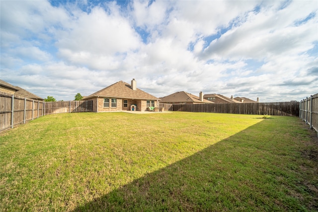view of yard with a fenced backyard and a patio