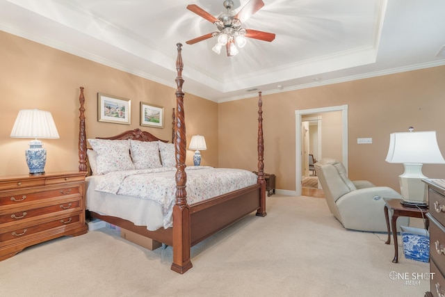 bedroom featuring light carpet, a tray ceiling, baseboards, ceiling fan, and ornamental molding