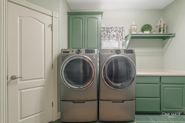laundry area featuring washing machine and clothes dryer and cabinet space