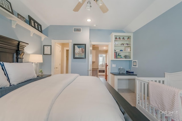 bedroom featuring lofted ceiling, visible vents, and ceiling fan