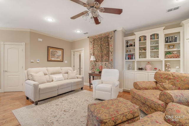 living room featuring light wood-type flooring, visible vents, recessed lighting, a ceiling fan, and ornamental molding