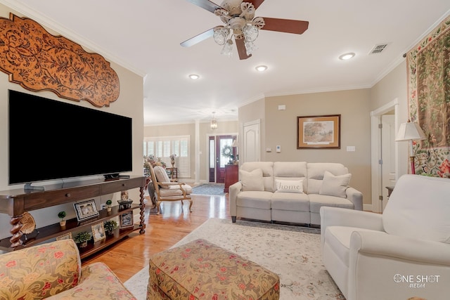 living room with a ceiling fan, wood finished floors, recessed lighting, and ornamental molding