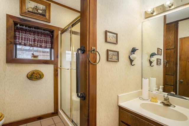 bathroom with vanity, tile patterned floors, a stall shower, and wallpapered walls