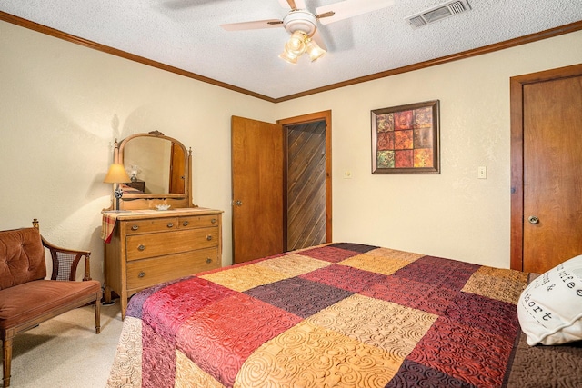 carpeted bedroom featuring visible vents, ornamental molding, a textured ceiling, and a ceiling fan