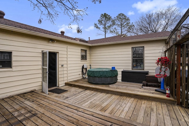wooden terrace with an outdoor hot tub