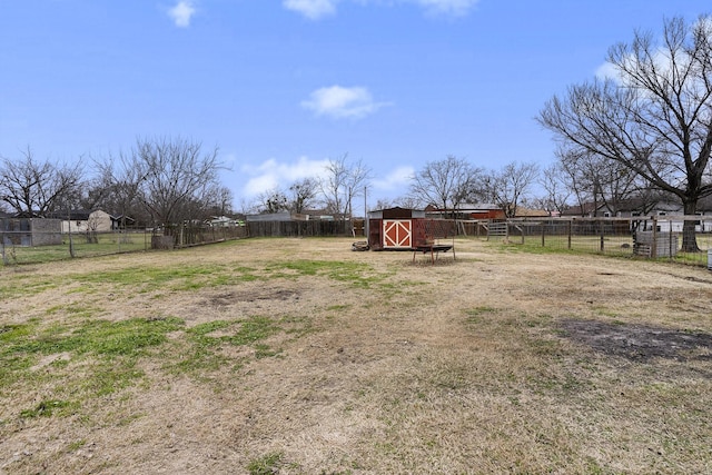 view of yard with an outdoor structure and fence