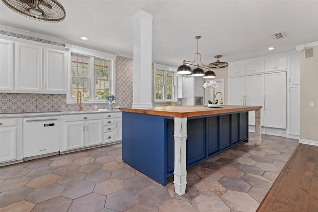 kitchen featuring dishwasher, white cabinets, butcher block countertops, and visible vents