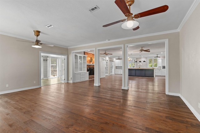 unfurnished living room featuring ceiling fan, wood finished floors, and visible vents