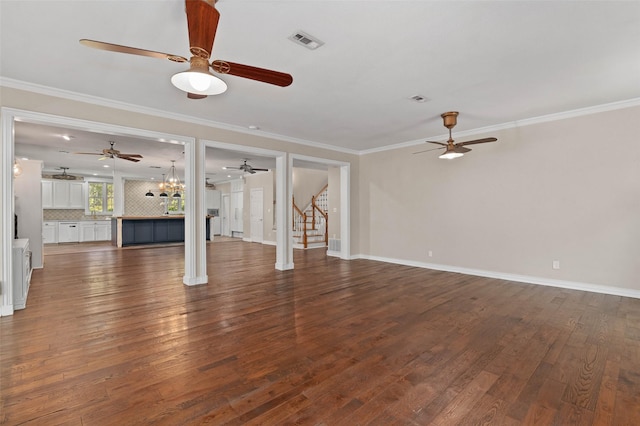 unfurnished living room with visible vents, a ceiling fan, stairs, and dark wood-style flooring