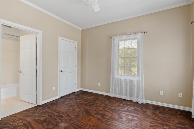 unfurnished bedroom featuring baseboards and crown molding