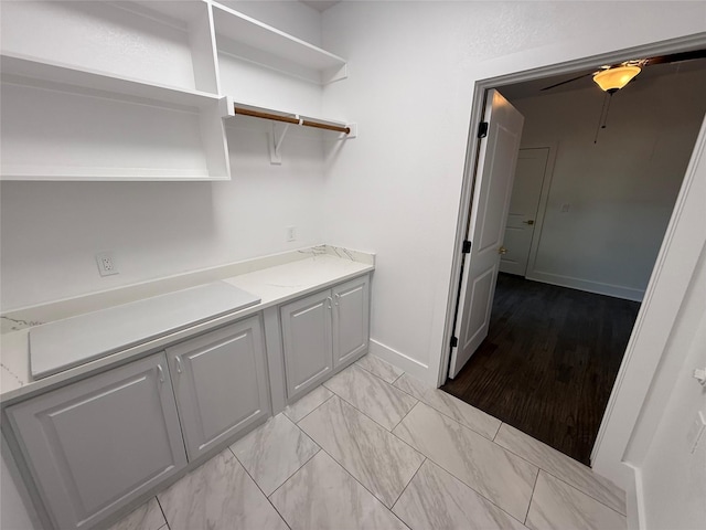 laundry area with baseboards