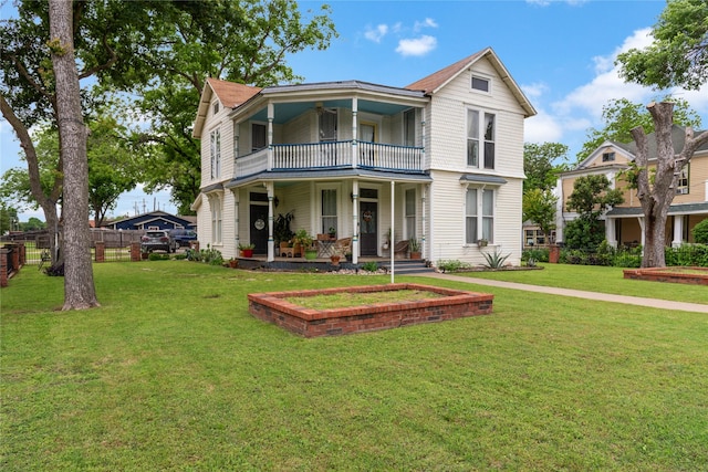501 N Anglin St, Cleburne, TX 76031 - victorian home with a front lawn, fence, a porch, and a balcony
