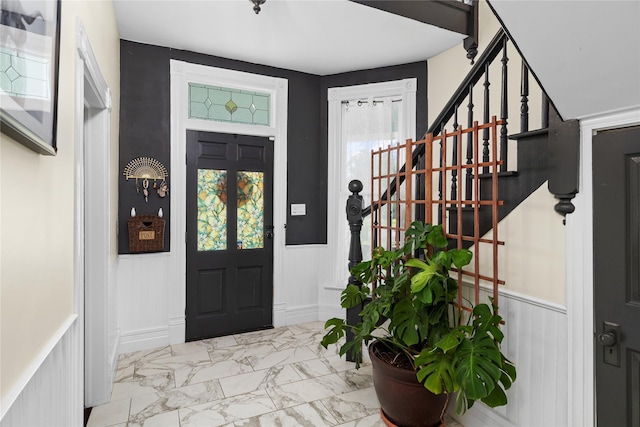 501 N Anglin St, Cleburne, TX 76031 - entryway featuring marble finish floor, a decorative wall, a wainscoted wall, and stairs