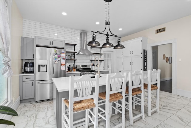 501 N Anglin St, Cleburne, TX 76031 - kitchen featuring wall chimney range hood, gray cabinets, marble finish floor, stainless steel appliances, and light countertops