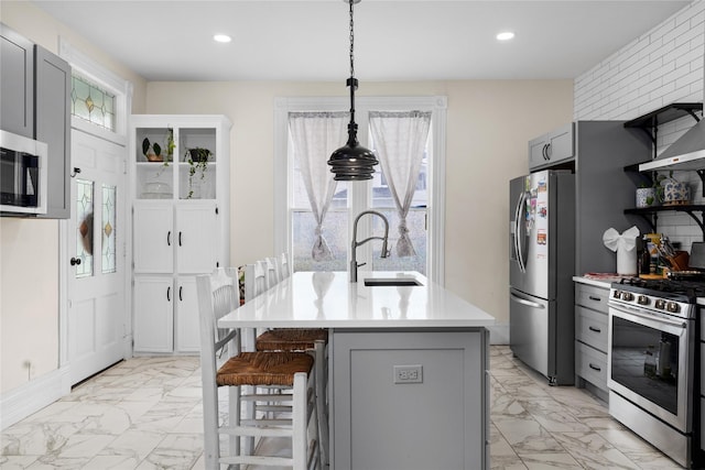 501 N Anglin St, Cleburne, TX 76031 - kitchen featuring marble finish floor, gray cabinetry, stainless steel appliances, and a sink