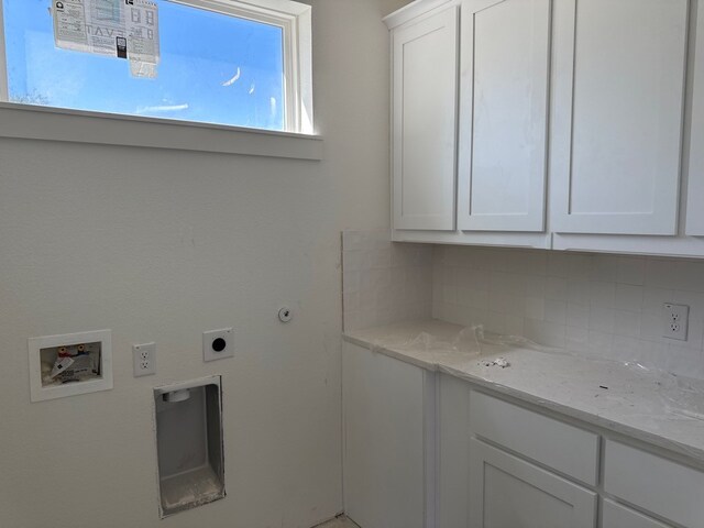 washroom with hookup for an electric dryer, cabinet space, and washer hookup
