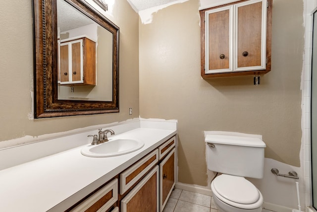full bathroom featuring a textured ceiling, toilet, walk in shower, tile patterned flooring, and vanity