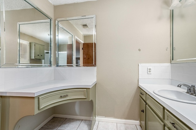 bathroom with visible vents, tile patterned floors, vanity, and decorative backsplash