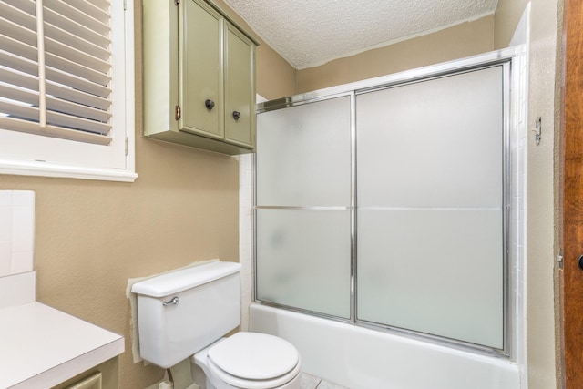 bathroom featuring shower / bath combination with glass door, a textured ceiling, toilet, and vanity