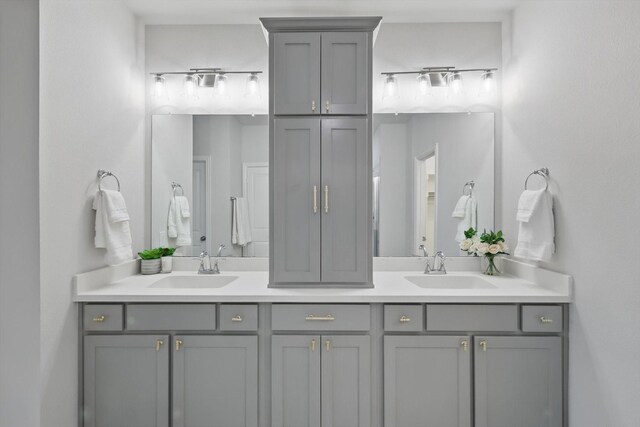 full bath with a sink and double vanity
