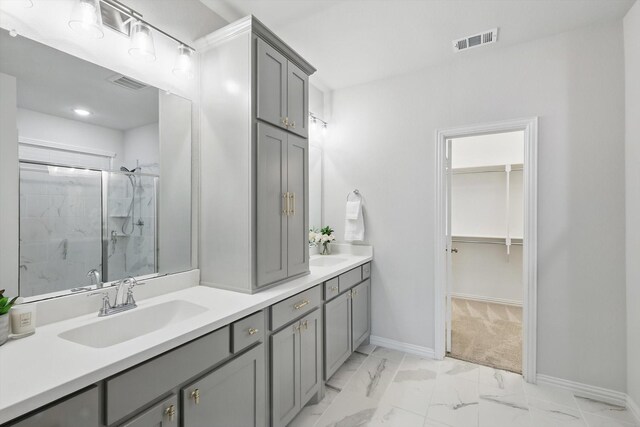 full bathroom with visible vents, marble finish floor, a stall shower, and a sink