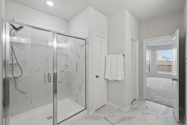 bathroom with baseboards, recessed lighting, marble finish floor, and a marble finish shower