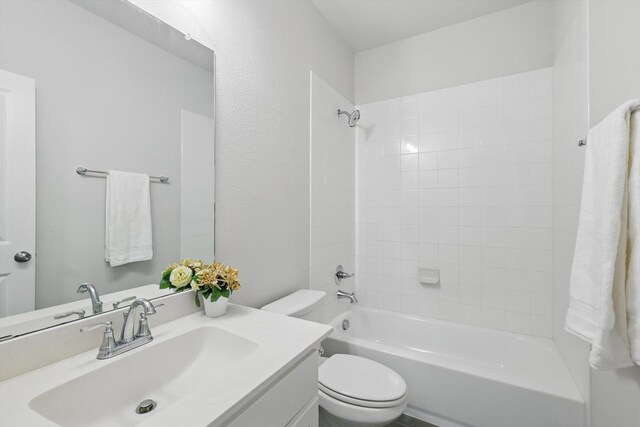 bathroom with toilet, shower / bathtub combination, and vanity