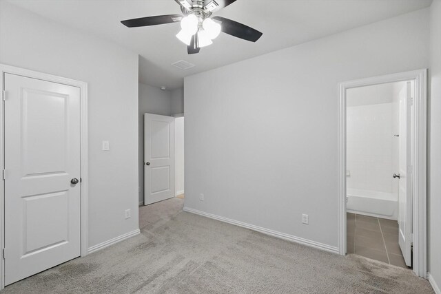 unfurnished bedroom with visible vents, carpet floors, ensuite bath, baseboards, and ceiling fan