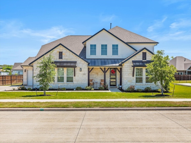 178 Dundee Ct, Argyle, TX 76226 - view of front facade with a standing seam roof, roof with shingles, a front yard, and fence