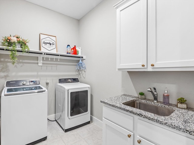 178 Dundee Ct, Argyle, TX 76226 - laundry room featuring a sink, light tile patterned floors, cabinet space, washing machine and dryer, and baseboards