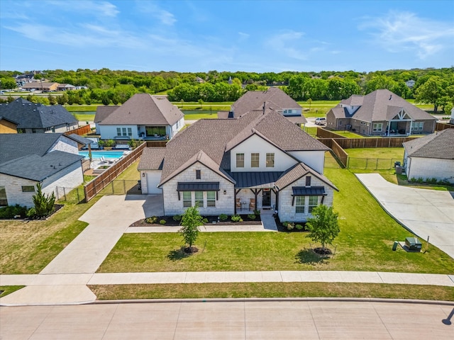 178 Dundee Ct, Argyle, TX 76226 - view of front facade with concrete driveway, a standing seam roof, fence, and a residential view