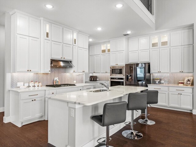 178 Dundee Ct, Argyle, TX 76226 - kitchen featuring tasteful backsplash, a sink, stainless steel appliances, white cabinets, and under cabinet range hood