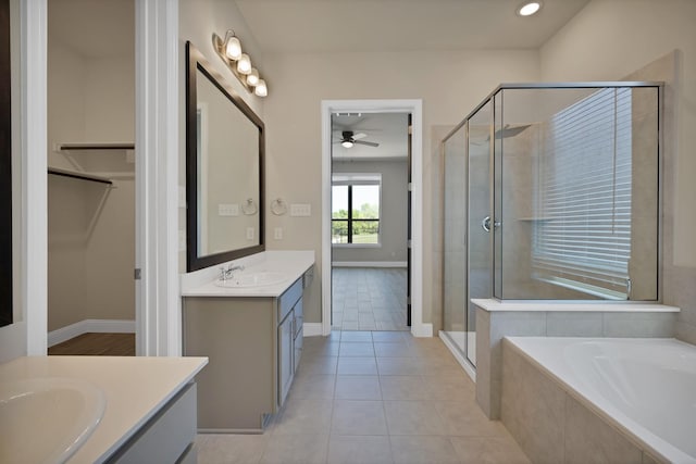 full bathroom with a bath, baseboards, a shower stall, ceiling fan, and vanity