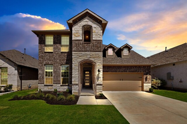 731 Calvin Way, Celina, TX 75009 - french country style house with driveway, brick siding, a front yard, a garage, and stone siding