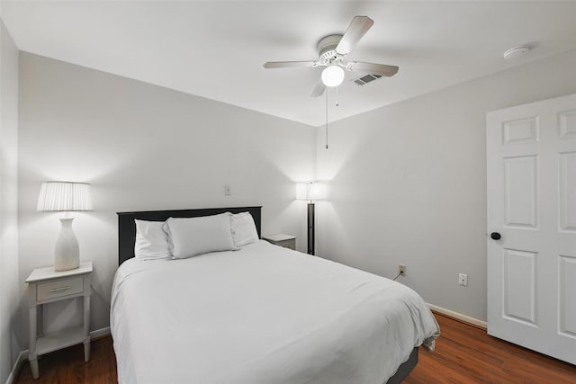 bedroom featuring baseboards, visible vents, ceiling fan, and dark wood-type flooring