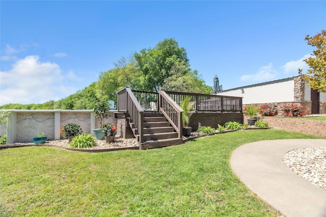 back of house featuring a lawn and a deck