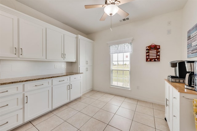 3450 County Road 2156, Caddo Mills, TX 75135 - kitchen featuring ceiling fan, white cabinets, baseboards, light stone counters, and light tile patterned flooring