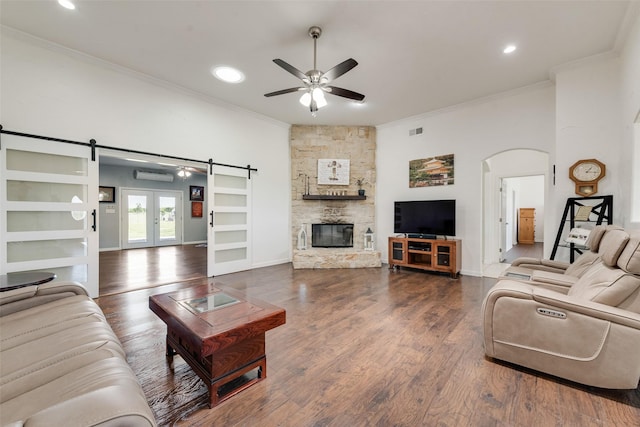 3450 County Road 2156, Caddo Mills, TX 75135 - living area with ornamental molding, ceiling fan, a barn door, a wall unit AC, and arched walkways