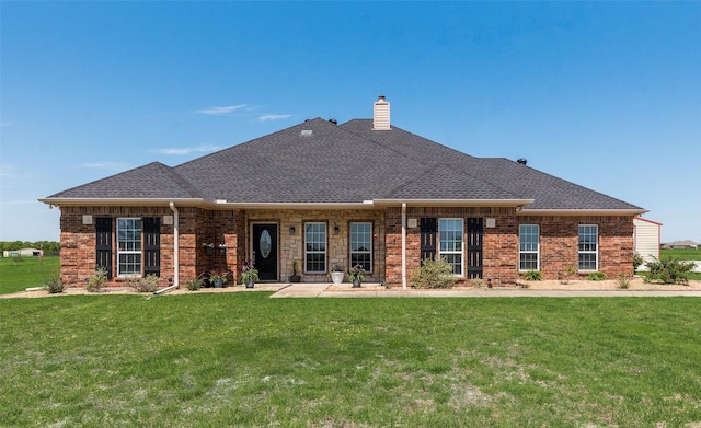 3450 County Road 2156, Caddo Mills, TX 75135 - back of house featuring a lawn, a chimney, brick siding, and a shingled roof