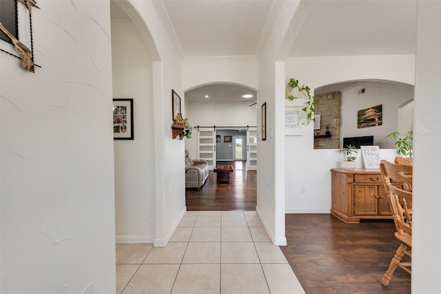 3450 County Road 2156, Caddo Mills, TX 75135 - hallway featuring crown molding, light wood-type flooring, baseboards, and arched walkways