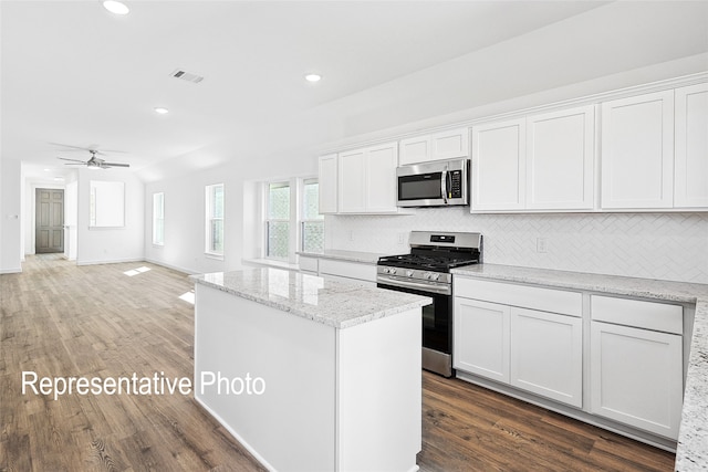 1385 Cider St, Forney, TX 75126 - kitchen featuring stainless steel appliances, a center island, backsplash, and a healthy amount of sunlight