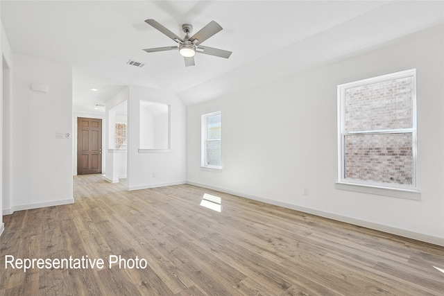 1385 Cider St, Forney, TX 75126 - empty room featuring vaulted ceiling, visible vents, a ceiling fan, baseboards, and light wood-style flooring