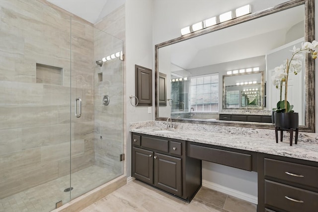 full bath with a shower stall and vanity