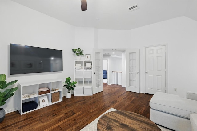 living room with wood finished floors, visible vents, and ceiling fan