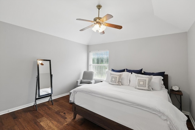bedroom with baseboards, vaulted ceiling, wood finished floors, and a ceiling fan