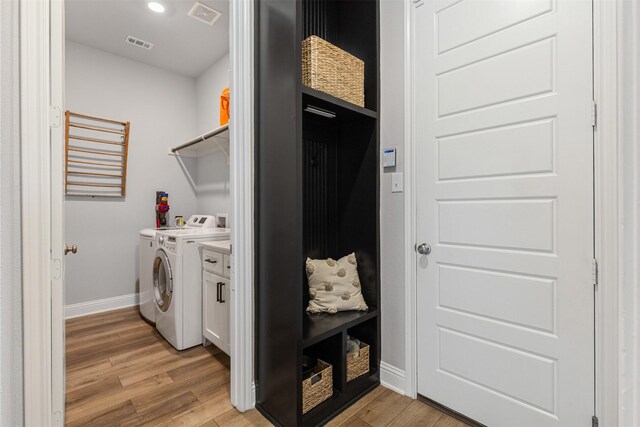 13645 Sweetwalk Pl, Fort Worth, TX 76008 - laundry room with baseboards, light wood-style flooring, washer and dryer, cabinet space, and recessed lighting