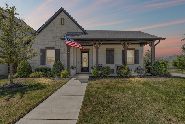 13645 Sweetwalk Pl, Fort Worth, TX 76008 - view of front of home featuring a front lawn, a porch, stone siding, and a shingled roof