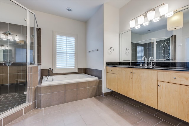 3907 Cole Ave Unit 5, Dallas, TX 75204 - full bathroom featuring tile patterned floors, a garden tub, vanity, and a shower stall