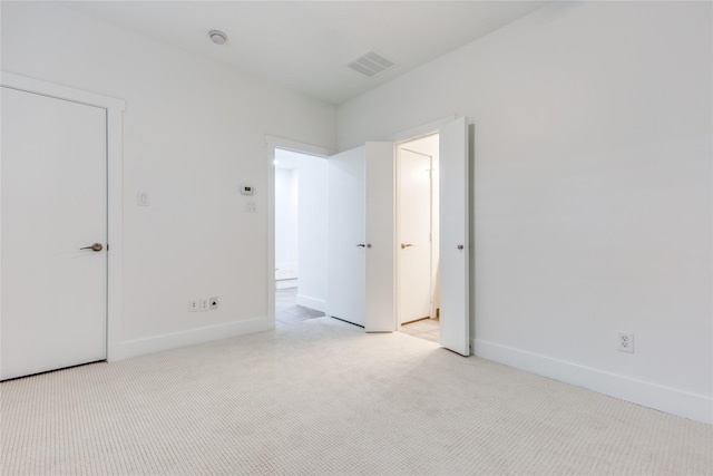 3907 Cole Ave Unit 5, Dallas, TX 75204 - unfurnished bedroom with baseboards, visible vents, and light colored carpet