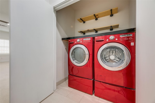 3907 Cole Ave Unit 5, Dallas, TX 75204 - washroom with tile patterned floors, washing machine and dryer, baseboards, visible vents, and laundry area